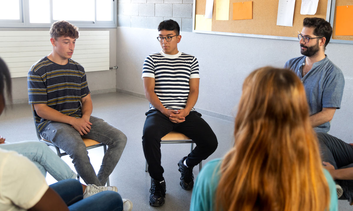 A group of high schoolers talking in a circle