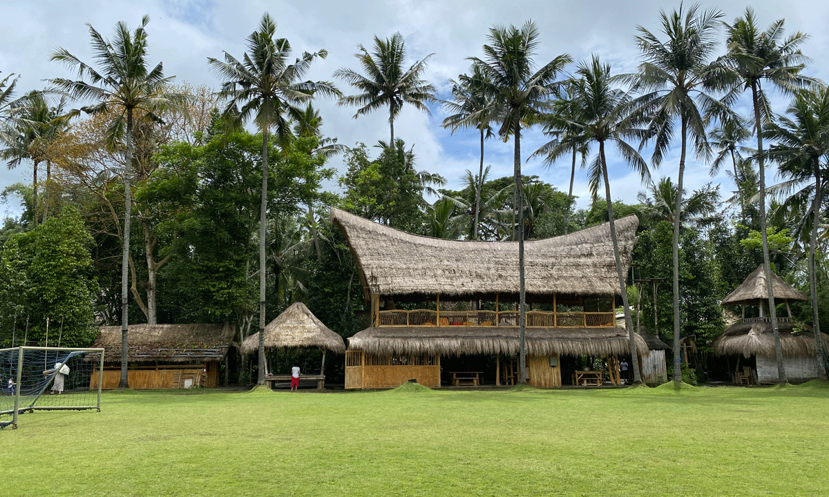 A photo of a multi-purpose meeting space and kitchen at the Green School Bali, made with native sustainable bamboo.